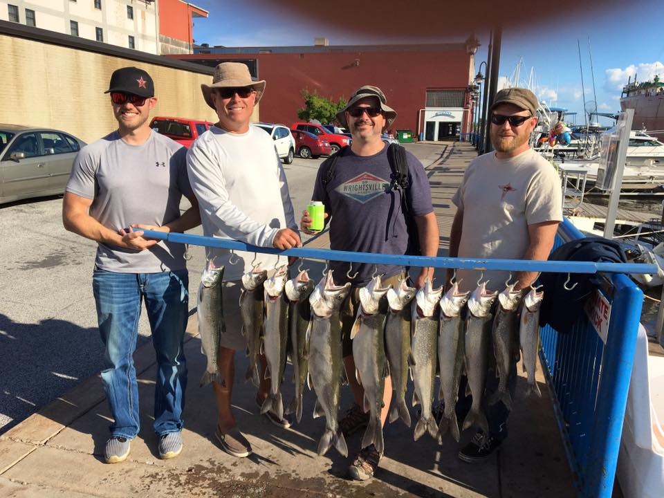 men holding fish they caught on happy hookers charter